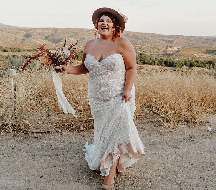 Plus size bride in white dress on countryside. Desktop Image